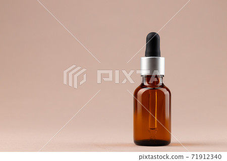 Beauty oil bottle with pipette on beige background 71912340