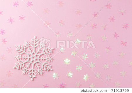 A gentle magic white snowflake from a fairy tale on a light pink background. A gentle magic white snowflake from a fairy tale on a light pink background. 71913799
