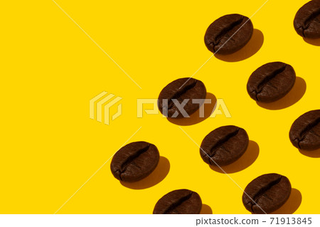 Coffee beans on an orange background. Coffee beans on an orange background. 71913845
