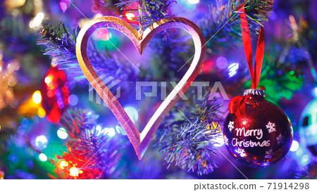 Christmas tree with heart shape decoration and purple illumination, close-up view Christmas tree with heart shape decoration and purple illumination, close-up view 71914298