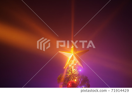 Christmas tree with festive lights, purple background 71914429