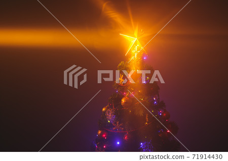 Christmas tree with shining star and dense smoke 71914430