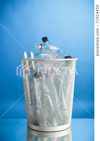trash can with wasted plastic bottles, blue background trash can with wasted plastic bottles, blue background 71914450