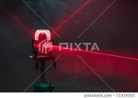 laser level tool red light beams in smoke 71914565
