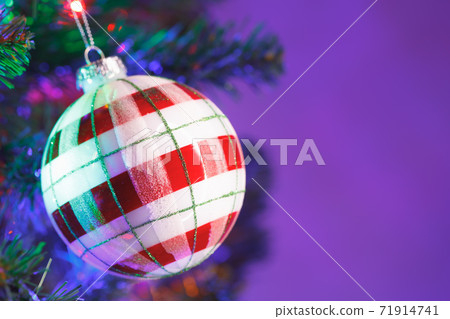 Christmas tree red and white striped ball decoration, close-up view Christmas tree red and white striped ball decoration, close-up view 71914741