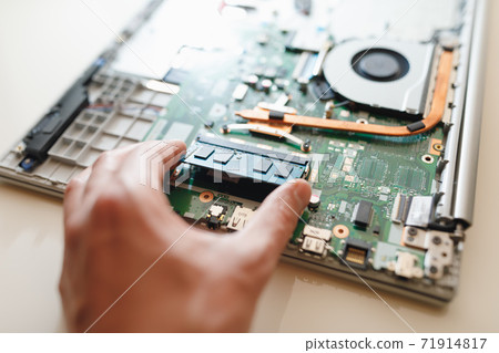 hand of repairman holding a ram sodimm memory module, laptop upgrade 71914817