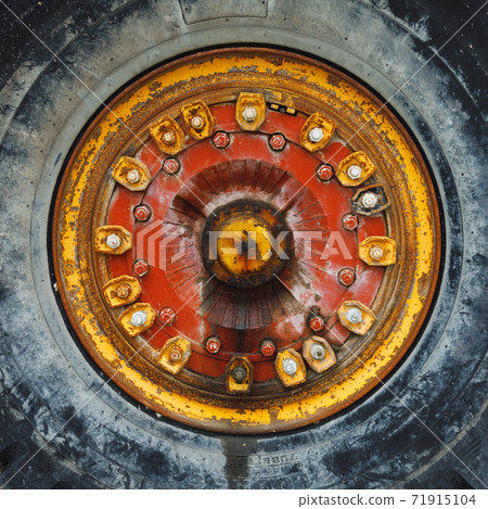 old rusty wheel of haul truck, close-up view old rusty wheel of haul truck, close-up view 71915104