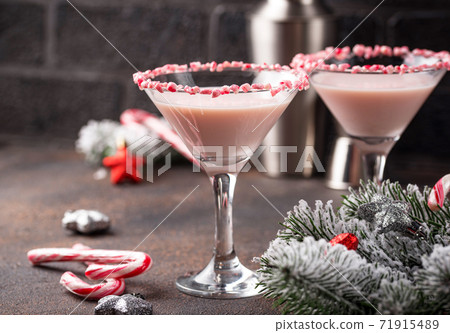 Pink peppermint martini with candy cane rim 71915489