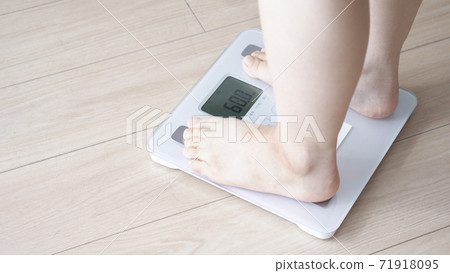 A woman on a scale 71918095