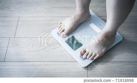 A woman on a scale 71918098