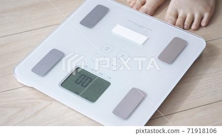 A woman on a scale 71918106