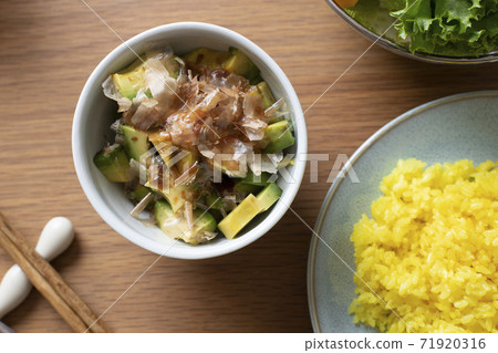 Table with turmeric rice and avocado bonito flakes 71920316