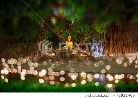 monks sitting meditate with many candle in Thai temple at night , Chiangmai ,Thailand, 71921409