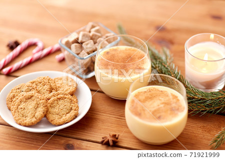 glasses of eggnog, oatmeal cookies and fir branch glasses of eggnog, oatmeal cookies and fir branch 71921999