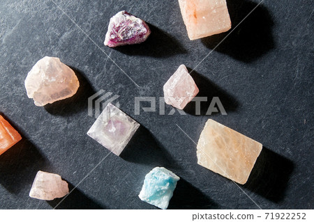 quartz crystal pyramid and gem stones on slate 71922252