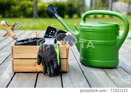 box with garden tools and watering can in summer 71922271