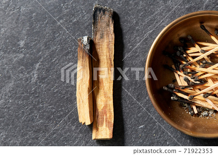 palo santo sticks and cup with burnt matches 71922353