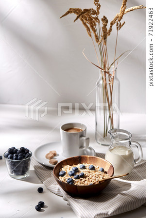oatmeal with blueberries, milk and cup of coffee oatmeal with blueberries, milk and cup of coffee 71922463
