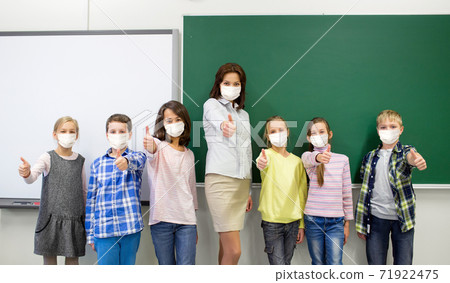 students and school teacher in mask show thumbs up students and school teacher in mask show thumbs up 71922475