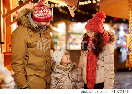 happy family at christmas market in city 71922486