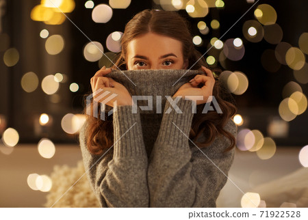 young woman in woolen sweater at night young woman in woolen sweater at night 71922528