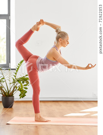 woman doing lord of the dance pose at yoga studio woman doing lord of the dance pose at yoga studio 71922853