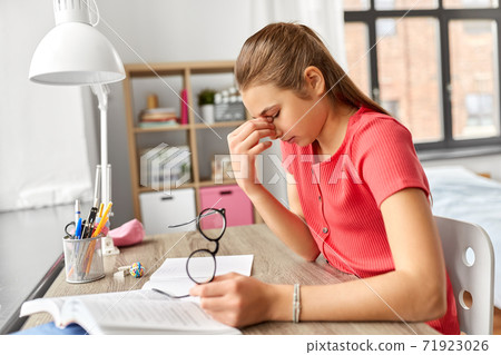 tired teenage student girl with glasses at home tired teenage student girl with glasses at home 71923026