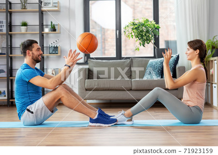 happy couple exercising with ball at home 71923159
