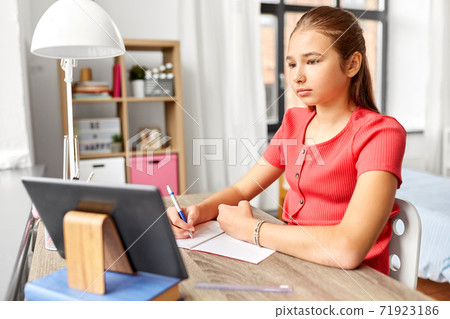 student girl with tablet pc learning at home 71923186