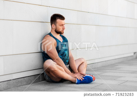 man doing sports and stretching outdoors man doing sports and stretching outdoors 71923283