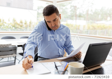 man calling on smartphone at home office man calling on smartphone at home office 71923410