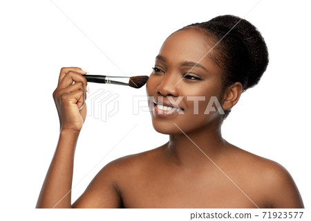 woman with make up brush applying blush to face woman with make up brush applying blush to face 71923577