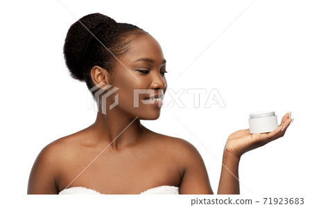 smiling african american woman with moisturizer smiling african american woman with moisturizer 71923683