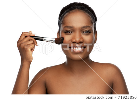 woman with make up brush applying blush to face woman with make up brush applying blush to face 71923856
