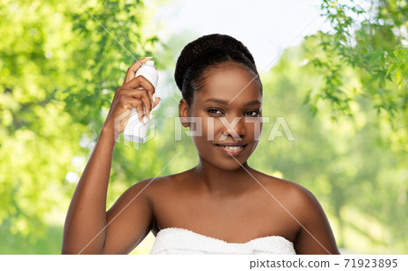 young african woman with hairspray 71923895
