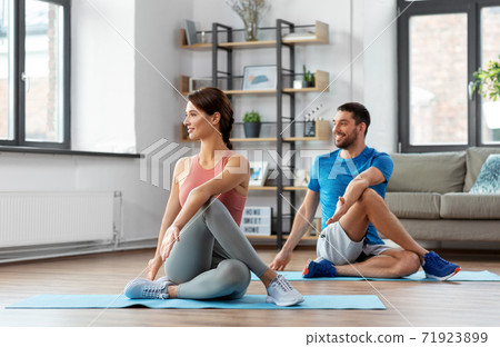 happy couple exercising at home 71923899