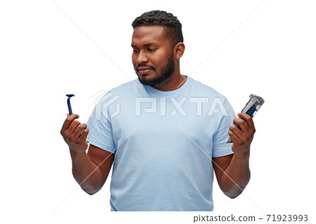 african man with razor blade and trimmer african man with razor blade and trimmer 71923993