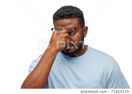 tired african man in lasses touching nose bridge tired african man in lasses touching nose bridge 71924219