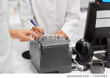 pharmacist and customer at cash register pharmacist and customer at cash register 71924463