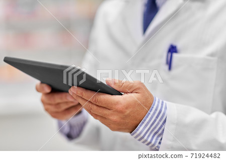 close up of senior pharmacist with tablet pc close up of senior pharmacist with tablet pc 71924482