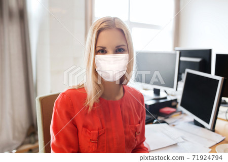 female office worker in mask with computers female office worker in mask with computers 71924794
