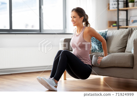 young woman exercising at home young woman exercising at home 71924999