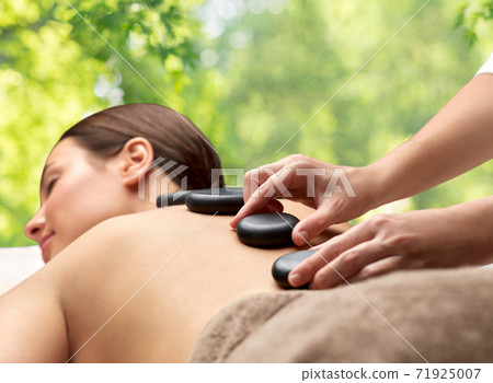 close up of woman having hot stone massage at spa close up of woman having hot stone massage at spa 71925007