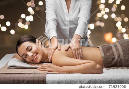 woman lying and having back massage at spa woman lying and having back massage at spa 71925008