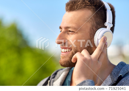 man in headphones listening to music outdoors man in headphones listening to music outdoors 71925041