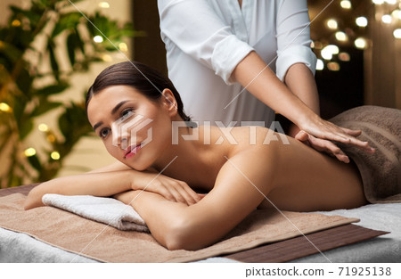 woman lying and having back massage at spa 71925138