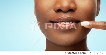 african american woman pointing to her mouth african american woman pointing to her mouth 71925142