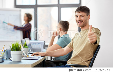 happy man showing thumbs up at office happy man showing thumbs up at office 71925237