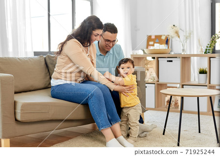 happy family with child sitting on sofa at home happy family with child sitting on sofa at home 71925244