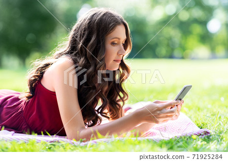 beautiful young woman with smartphone at park beautiful young woman with smartphone at park 71925284